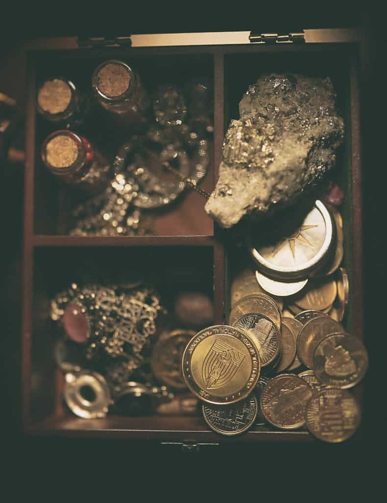 Capture of a treasure box filled with coins, jewelry, and a large rock.