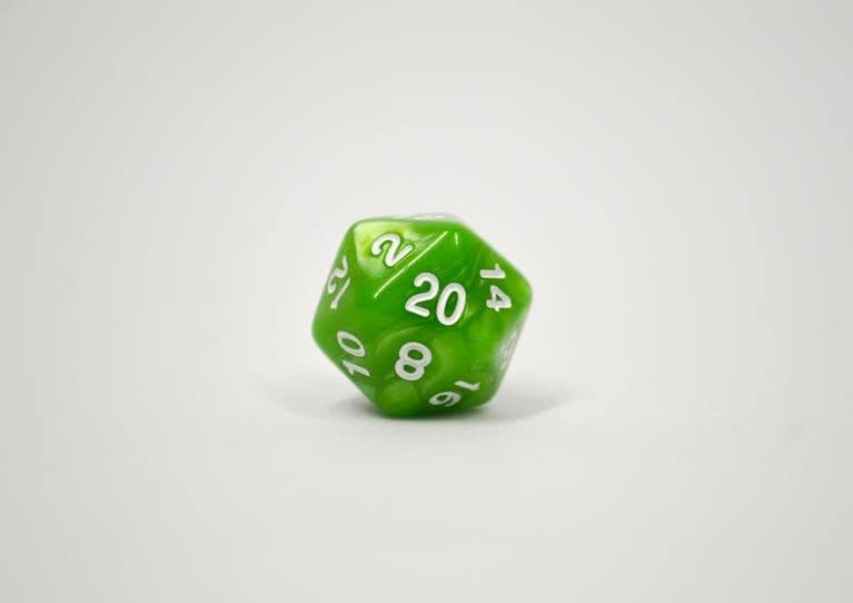 Close-up image of a green 20-sided dice used in tabletop role-playing games.