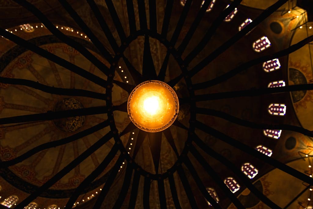 Symmetrical view of a chandelier in Hagia Sophia, Istanbul, showcasing intricate architectural detail. Symbolizing how players are the center of the campaign world.